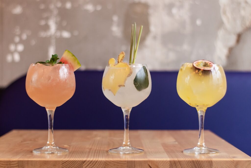 three clear glass goblet with assorted martini